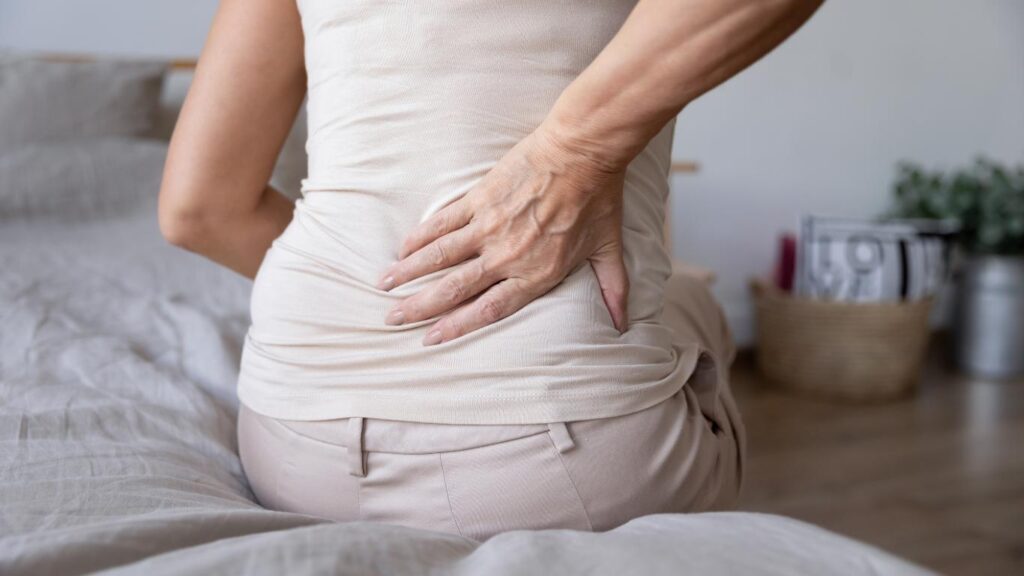 woman holds back due to pain