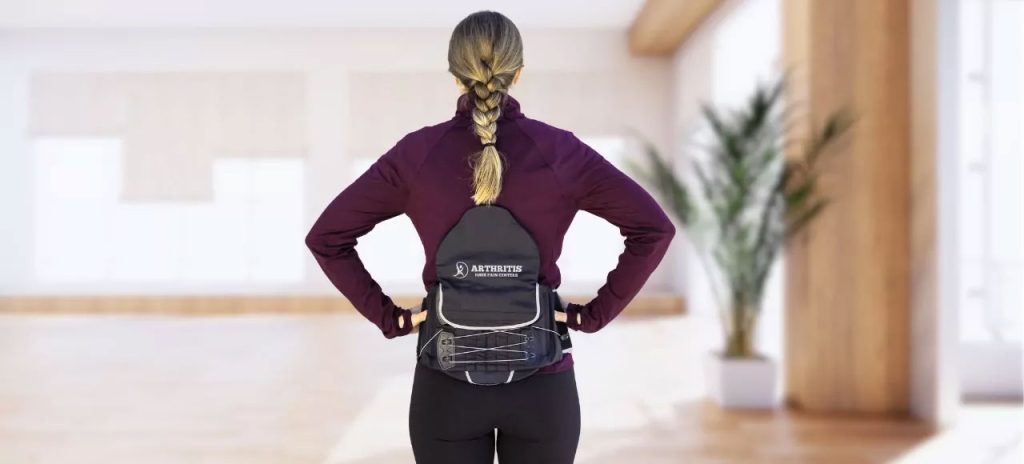 athletic woman wearing orthopedic back brace