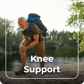 Man hiking, holding his knee in pain