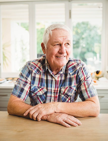 Older man sitting in kitchen