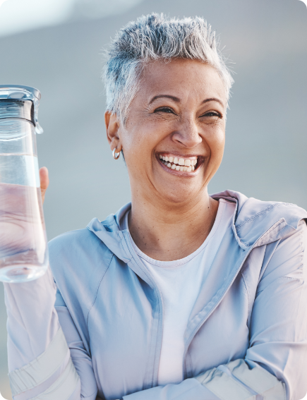 Woman with a water bottle smiling