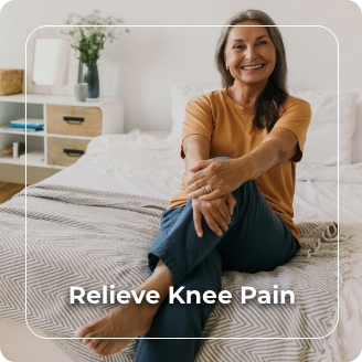 woman sitting on a bed, happy she doesn't have knee pain
