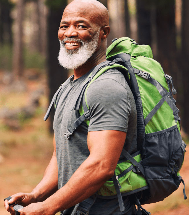 Man hiking with green pack