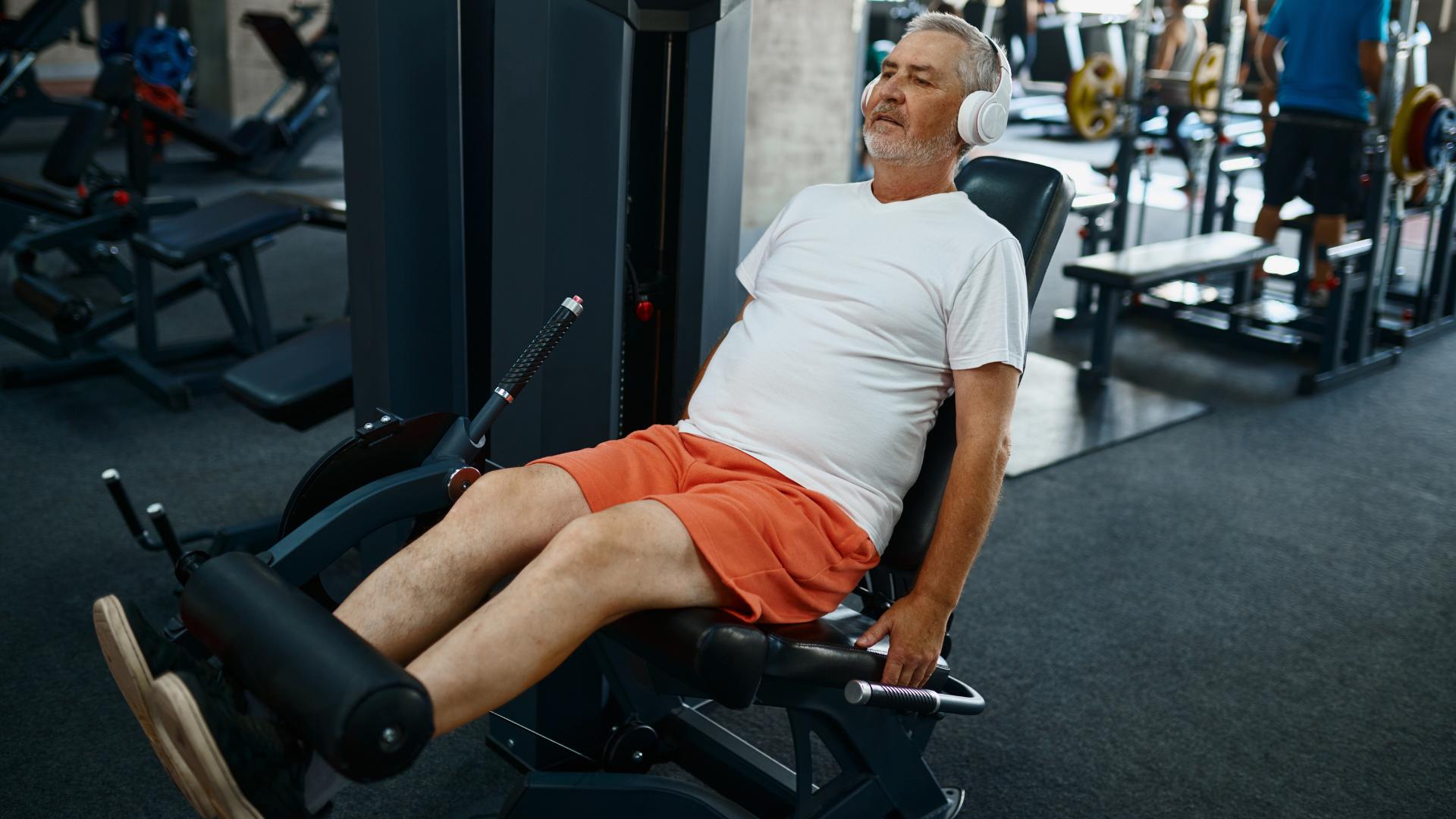 middle aged man works out his legs at gym seeking to strengthen sartorious muscle