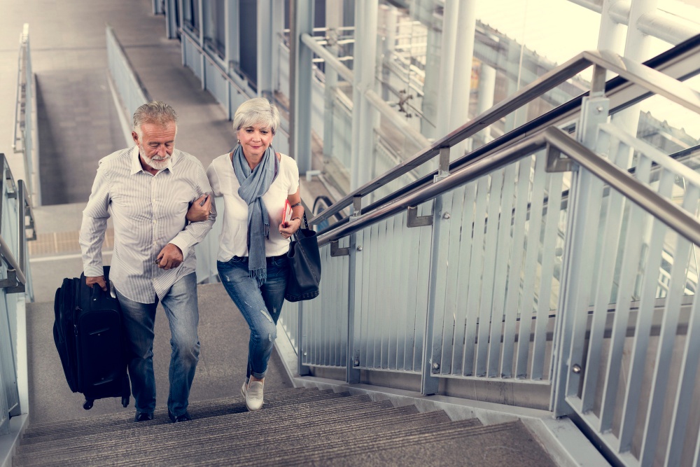 Senior couple walking upstairs together maintaining healthy knee motion and stability.